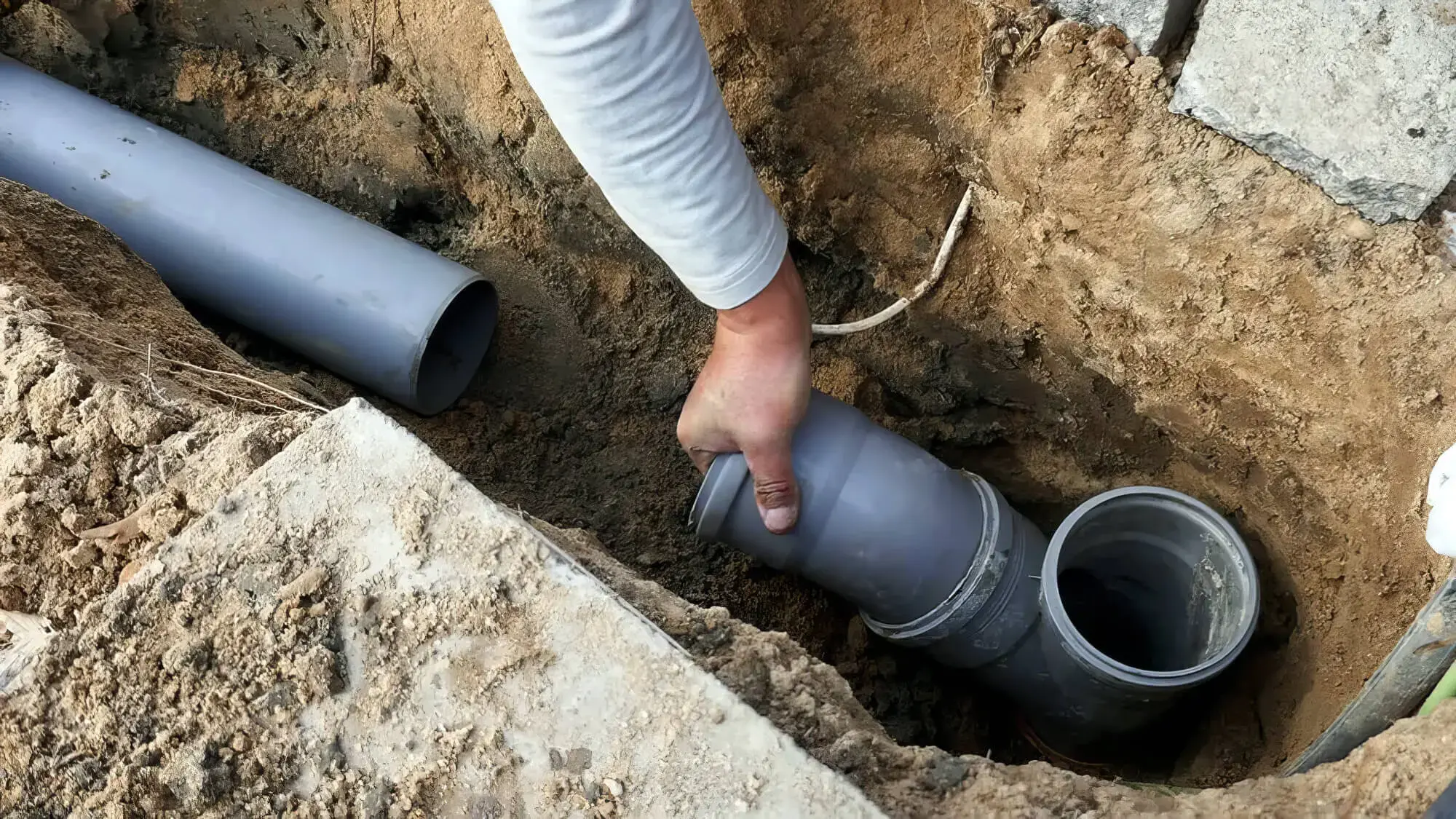 Plumber removing old corroded supply pipes and fittings during a repipe