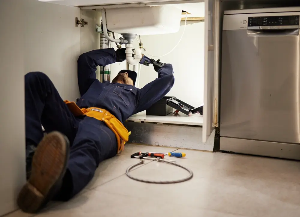 Plumber performing a preventative maintenance check on a home water system